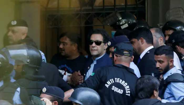 Security officers escort former prime minister Imran Khan as he appeared in Islamabad High Court in this undated picture. — Reuters