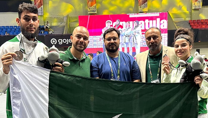 Pakistans Ikhtshamul Haq (first from left) wins silver and Maleeha Ali (first from right) earns bronze medal at 6th Asian Taekwondo Open Championship. — Reporter