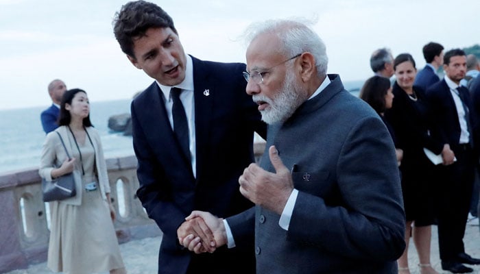 Canadas Prime Minister Justin Trudeau (left) shakes hands with Indian Prime Minister Narendra Modi after the family photo with invited guests at the G7 summit in Biarritz, France, August 25, 2019. — Reuters