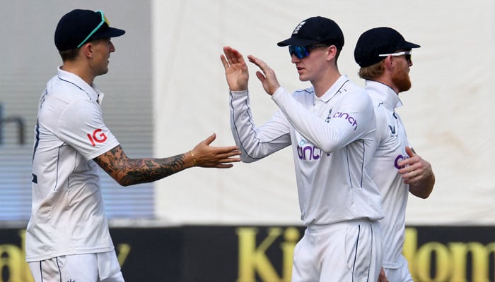 Englands Brydon Carse celebrates with Harry Brook after taking the catch to dismiss Pakistans Noman Ali, off the bowling of Jack Leach during second Test at Multan Cricket Stadium, Multan on October 16, 2024. — Reuters