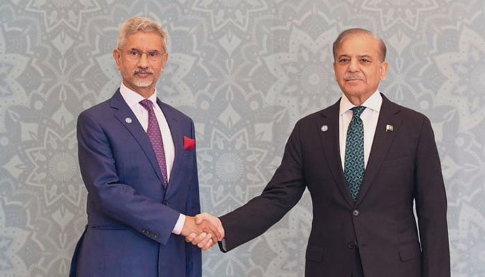 Indian Foreign Minister Dr S Jaishankar shakes hands with Prime Minister Shehbaz Sharif during the SCO summit