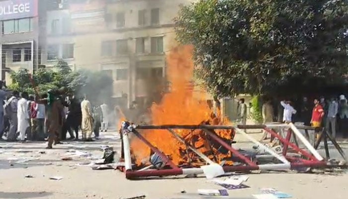 Furniture and police barricade burns after being set ablaze by protesting students in Rawalpindi on October 17, 2024. — Reporter