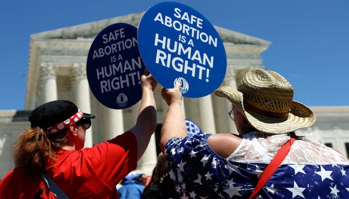 Abortion rights activists hold signs as they gather at the US Supreme Court to mark the second anniversary of the Court overturning Roe v. Wade, in Washington, US, June 24, 2024.— Reuters