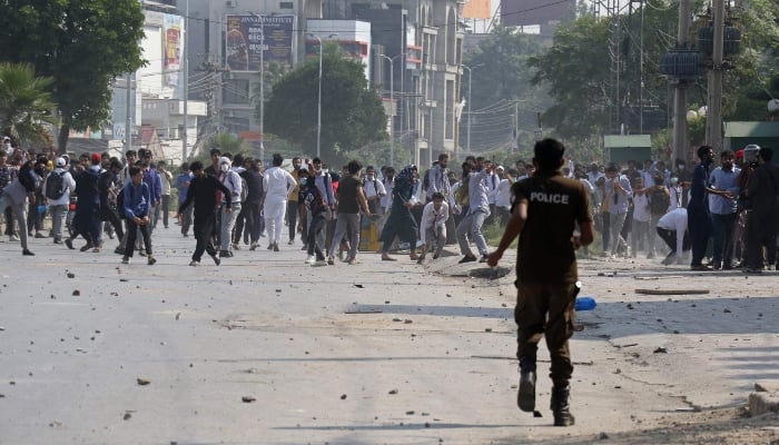 Students hurl stones towards security personnel during a demonstration to condemn the alleged rape of a female student in Rawalpindi on October 17, 2024. —AFP