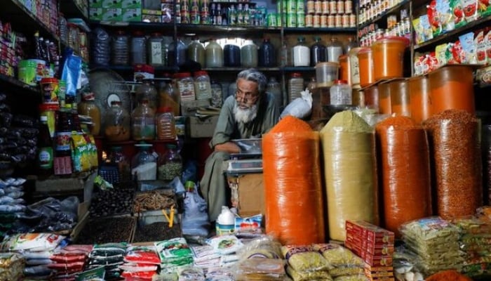 A shopkeeper waits for customers while selling spices and groceries items at the retail market in Karachi on June 11, 2020. —Reuters