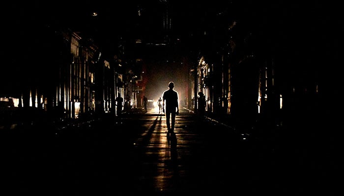 People walk in the street at night as Cuba is hit by an island-wide blackout, in Havana, Cuba, October 18, 2024. — Reuters