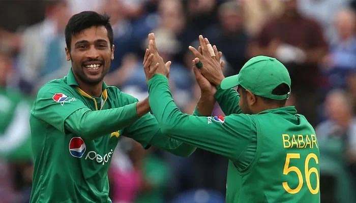 Pakistan pacer Mohammad Amir (L) and former skipper Babar Azam. — AFP/File