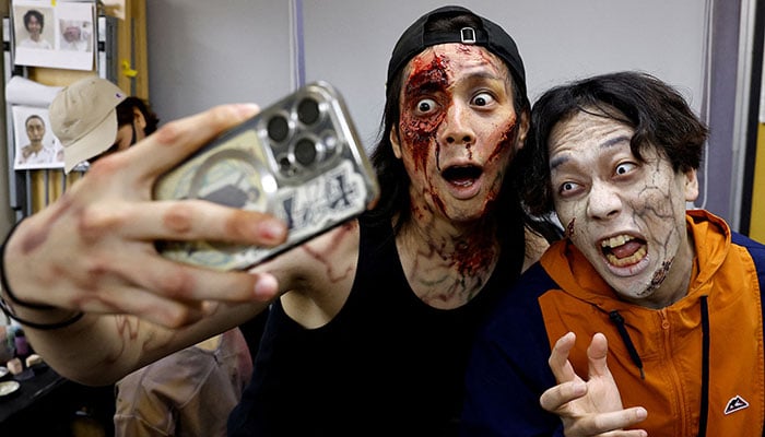 Artists dressed as zombies perform inside a Zombie Shinkansen bullet train bound for Osaka from Tokyo, inspired by the South Korean film 'Train to Busan' ahead of the Halloween season, Japan, October 19, 2024. - Reuters