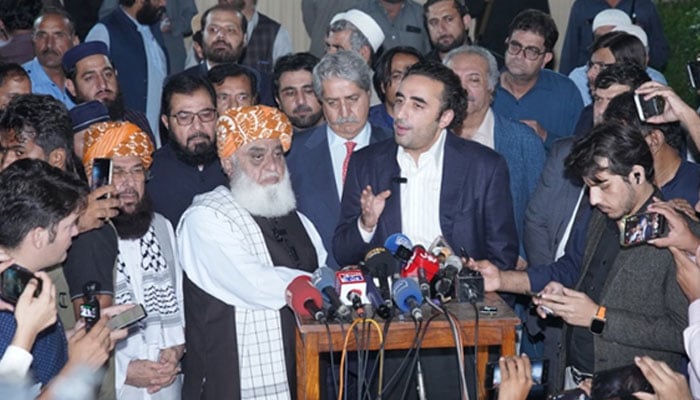 JUI-F Chief Maulana Fazlur Rehman (centre-left) and PPP Chairman Bilawal Bhutto-Zardari address a joint press conference outside the formers residence on October 20, 2024. — X/@MediaCellPPP