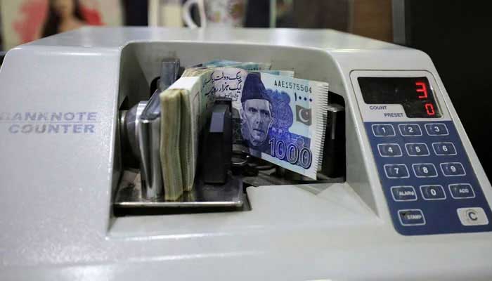 Pakistani rupee notes are seen in a counting machine at a bank in Peshawar, August 22, 2023. — Reuters