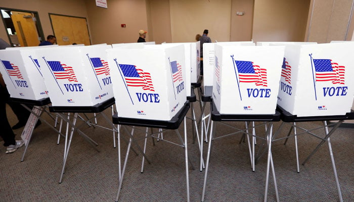 Poll workers with the Hillsborough County Supervisor of Elections Office, work to setup early voting equipment at the Seffner-Mango Branch Library in Seffner, Florida, US, August 2, 2024 — Reuters.