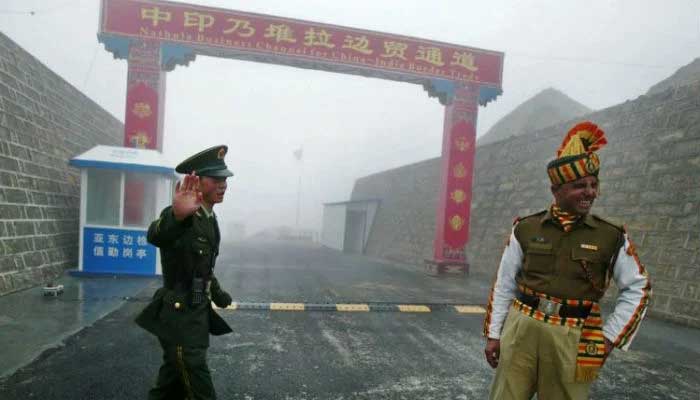 This file photo taken on July 10, 2008, shows a Chinese soldier next to an Indian soldier at the Nathu La border crossing between India and China in Indias northeastern Sikkim state. — AFP