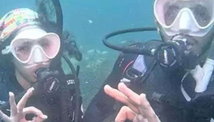 The picture shows couple tying knot under water. — Saudi Ajel Newspaper