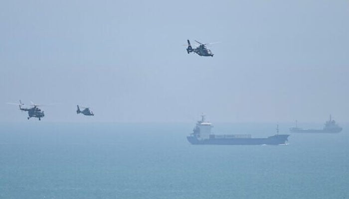 Chinese military helicopters fly past Pingtan island, one of mainland Chinas closest point from Taiwan, in Fujian province on August 4, 2022. — AFP