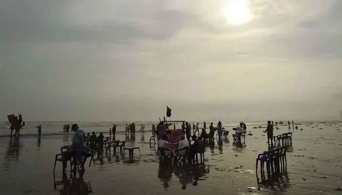 People pictured at Karachis sea view beach on June 16, 2023. — INP