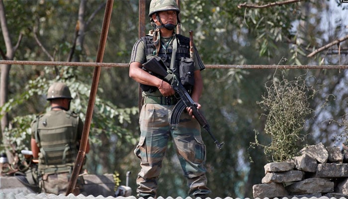 An undated image showing Indian army soldiers keep guard on top of a shop along a highway. — Reuters/File