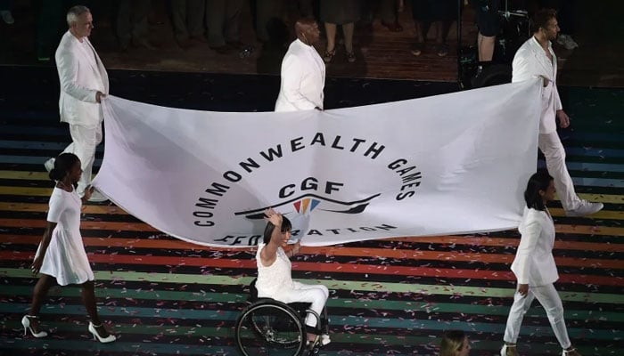 A representational image showing flagbearers of the Commonwealth Games Federation display the flag during the opening ceremony of the 2014 Commonwealth Games at Celtic Park in Glasgow on July 23, 2014. — AFP