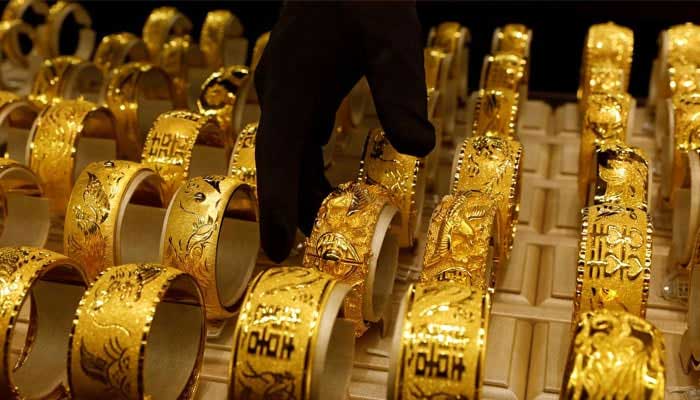 Gold ornaments displayed in a showcase at a jewellers shop can be seen in this undated photo. — Reuters/File