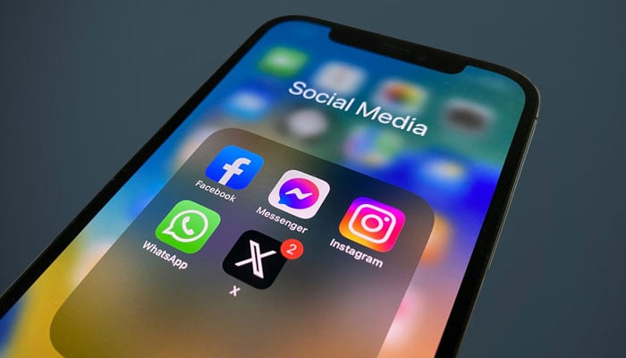 A representational image showing the icons of different social media platforms displayed on a phone screen. — Unsplash