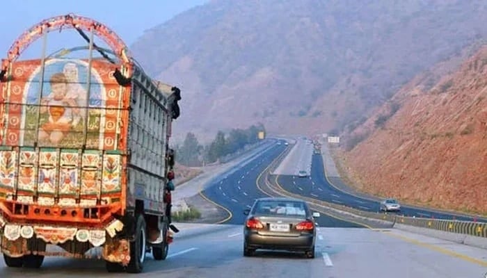 A representational image showing a car and a truck travelling on a section of a motorway. — AFP/File