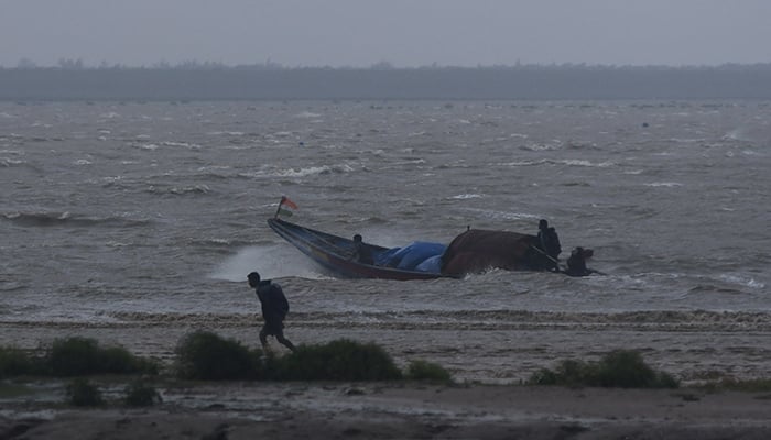 Fishermen attempt to bring their boat back to shore during high tide before Cyclone Dana makes landfall in Bhadrak district in the eastern state of Odisha, India, October 24, 2024. — Reuters