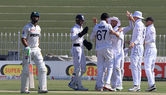 Pakistans Shan Masood walks after losing his wicket, caught by Englands Ollie Pope off the bowling of Englands Shoaib Bashir during the third Test between England and Pakistan at the Rawalpindi Cricket Stadium, in Rawalpindi, Pakistan, on October 25, 2024. — Reuters