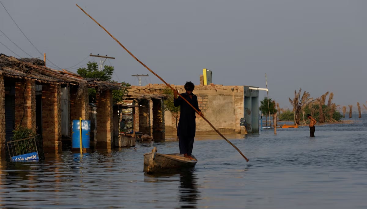 A man rows his boat as he passes through flooded market, following rains and floods during the monsoon season in Bajara village, at the banks of Manchar lake, in Sindhs Sehwan district, on September 6, 2022. — Reuters