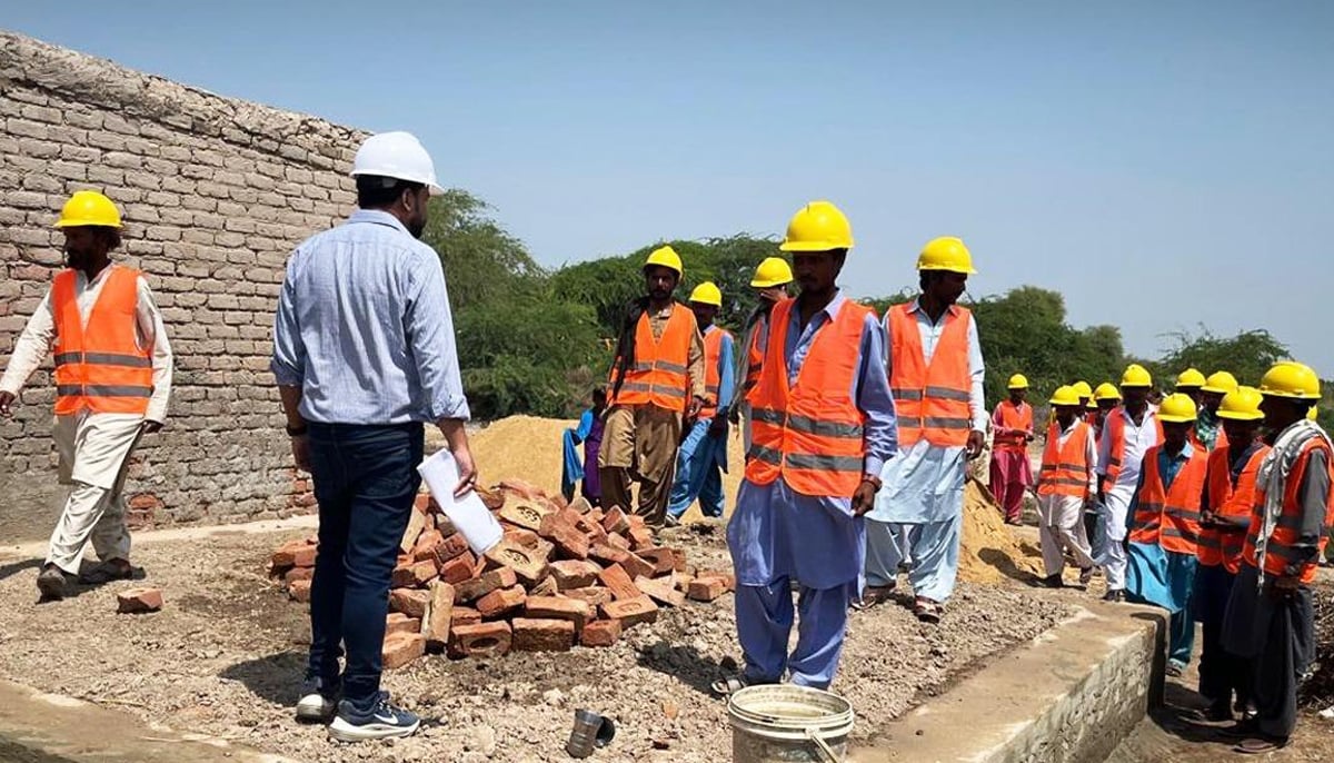 Workers seen constructing a structure in Sindh. — Facebook/Sindh Peoples Housing for Flood Affectees