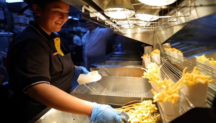 An employee cooks fries at a new restaurant in Moscow, Russia, on June 12, 2022.— Reuters