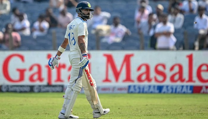 Indias Virat Kohli walks back to the dressing room after missing a full toss against New Zealand during the second day of the second Test at Pune on October 25, 2024. — AFP