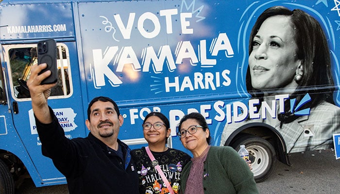 Supporters of Democratic presidential nominee US Vice President Kamala Harris get their picture taken beside a truck distributing merchandise in support of Harris, outside a campaign rally at The Alan Horwitz Sixth Man Centre, in Philadelphia, Pennsylvania, US October 27, 2024. — Reuters