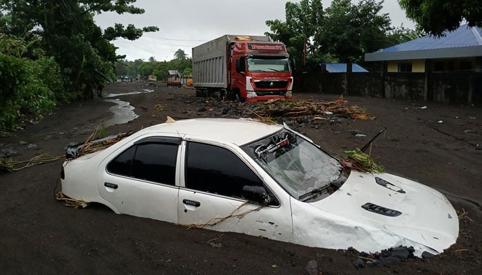 A vehicle is submerged on a street covered with mud due to heavy floods in the aftermath of Tropical Storm Trami on October 23, 2024, in this picture obtained from social media. — Reuters