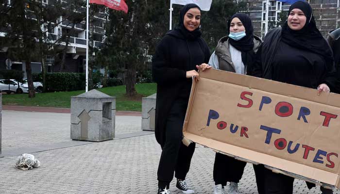 Supporters of the women soccer team Les Hijabeuses gather in front of the city hall in Lille as part of a protest as French Senate examines a bill featuring controversial hijab ban in competitive sports in France, February 16, 2022. The slogan reads Sport for all. — Reuters