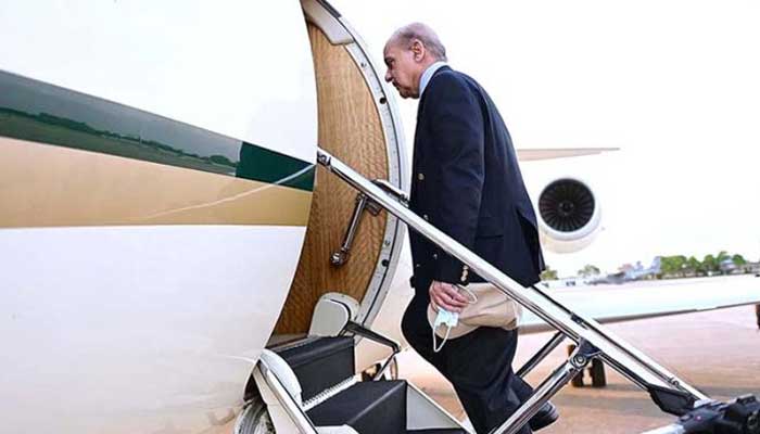 Prime Minister Shehbaz Sharif boards a Pakistan Air Force plane in this undated picture. — X/@PakPMO/File