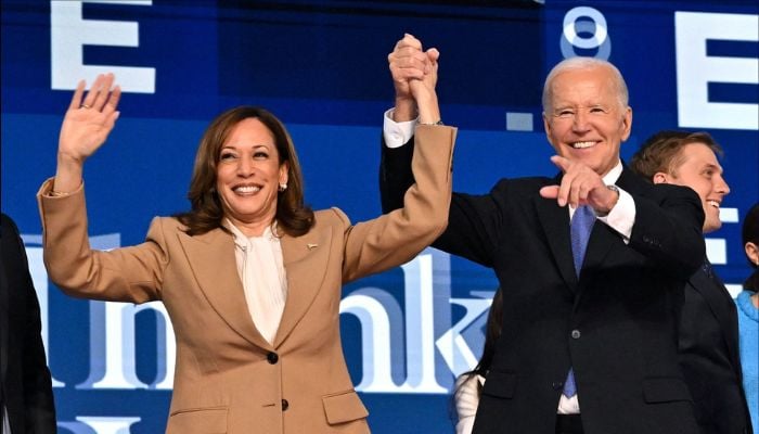 Vice President and 2024 Democratic presidential candidate Kamala Harris (L) and US President Joe Biden hold hands after a keynote address on the first day of the Democratic National Convention (DNC), Chicago, Illinois, August 19, 2024. — AFP