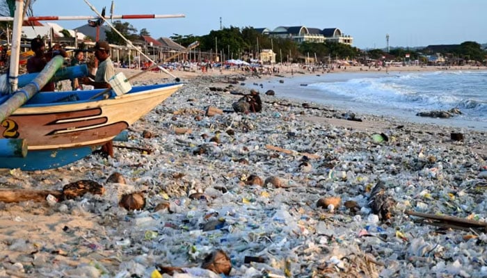 Plastic and other debris are washed ashore at Kedonganan Beach near Denpasar on Indonesias resort island of Bali on March 19, 2024. — AFP