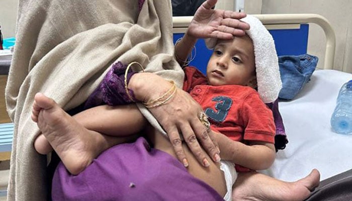 A representational image showing a child being taken care of by a caregiver in a hospital. — Reuters/File