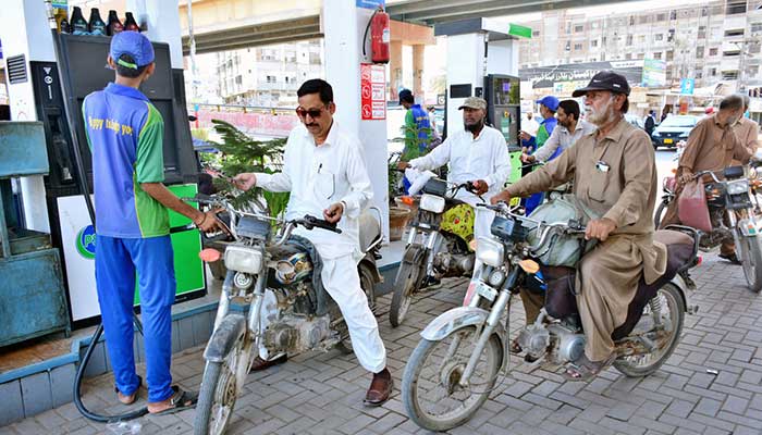 Motorcyclists waiting for their turn to fill fuel in their bikes at petrol pump on May 16, 2024. — APP