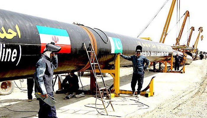 An undated image showing technicians working on a section of a pipeline linking Iran and Pakistan. — AFP/File