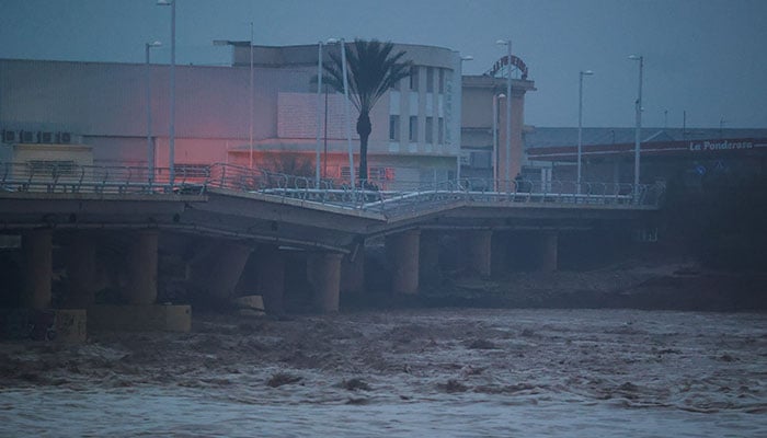 A river flows under a partially collapsed bridge affected by torrential rains that caused flooding in the town of Carlet, Valencia region, Spain on October 30, 2024. — Reuters