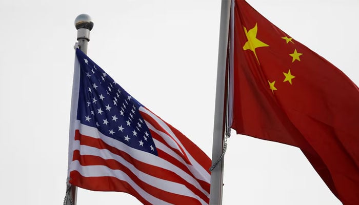 Chinese and US flags flutter outside the building of an American company in Beijing, China January 21, 2021. — Reuters