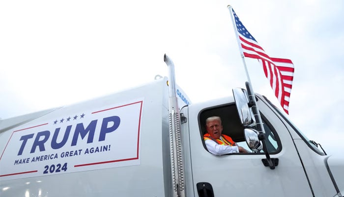 The image shows former US president Donald Trump campaigning in a garbage Truck in Green Bay, Wisconsin, on Wednesday. — Reuters/File