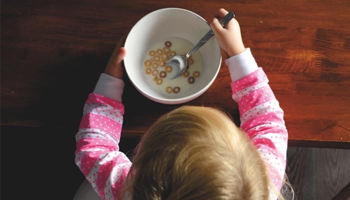 A representational image shows a toddler eating cereal. — Unsplash