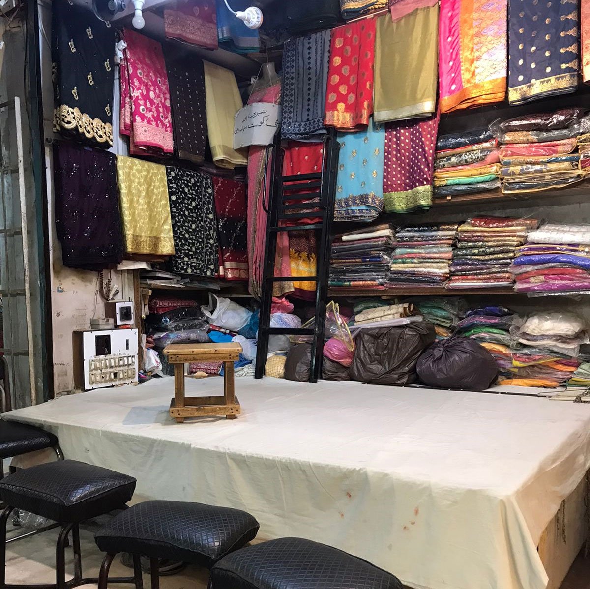 Zakis shop displays a variety of saris in different fabrics, including chaapa design, in Hyderi market, Karachi. — Photo by author