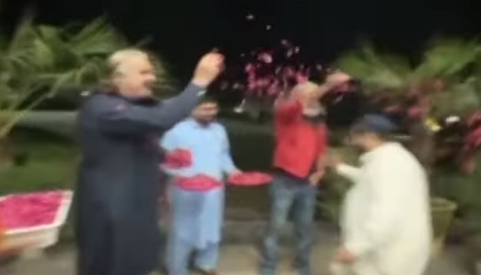 KP CM Ali Amin Gandapur shower flowers petals on a rescue personnel. — Screengrab via YouTube/Geo News