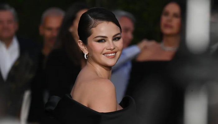 Selena Gomez Rare Impact Fund shakes hand with PacSun