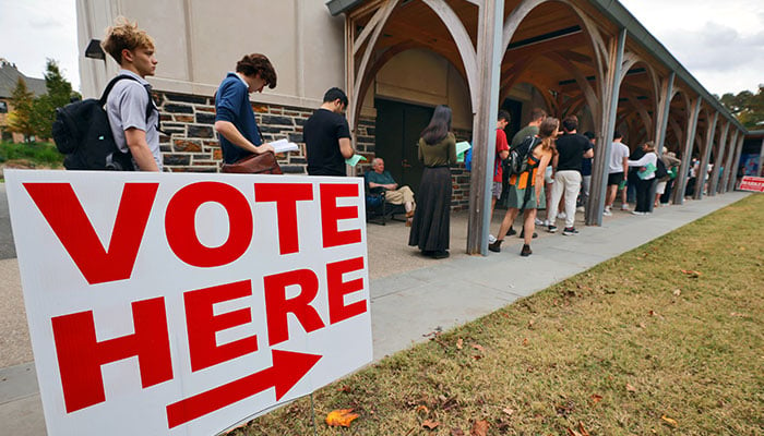 Duke University students wait in line with Durham County residents to vote at a campus polling station during the penultimate day of early voting in the state, in Durham, North Carolina, U.S., November 1, 2024 — Reuters