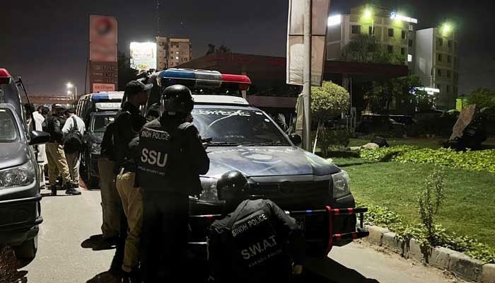 Police officers take position after a police office building was attacked by gunmen in Karachi, February 17, 2023. — Reuters