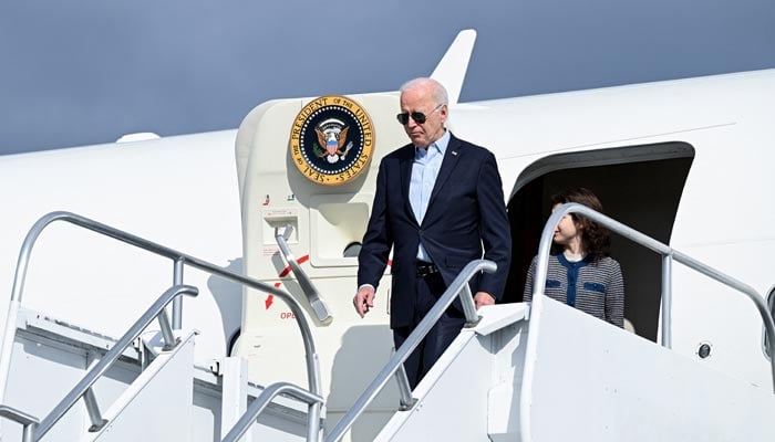 US President Joe Biden steps off Air Force One with his granddaughter Natalie Biden as they arrive at Wilkes-Barre Scranton International Airport in Avoca, Pennsylvania, US, November 2, 2024. – Reuters