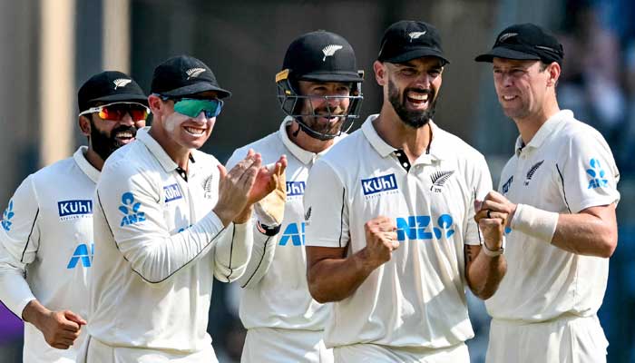 New Zealand players celebrate during the third day of the third and final Test against India at the Wankhede Stadium in Mumbai on November 3, 2024. — AFP